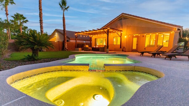 A house with a swimming pool, outdoor seating, and a covered patio area. - Golf and Backyard Getaway (Mesa)