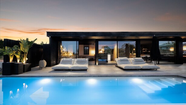 A modern outdoor pool area with lounge chairs and a wooden deck. - Estepona - Sleeps 8 - Pool - Pet Friendly - Garden (Estepona)