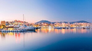 A coastal town with a marina, boats, and buildings reflecting on calm water. - Estepona - Sleeps 8 - Pool - Pet Friendly - Garden (Estepona)