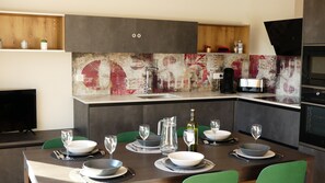 A modern kitchen with a dining area set for six.