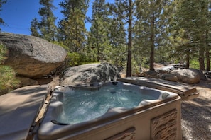 A hot tub surrounded by large rocks and pine trees. - Beautiful Boulder Bay Setting & Lake Views! Game Room! HOT TUB! (Big Bear Lake)