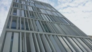 A modern building with a grid-like facade and large windows. - Stunningly Beautiful & Modern Apt. Small building (Miraflores)