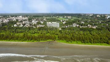 Situated amidst lush greenery, this hotel offers a serene coastal view.