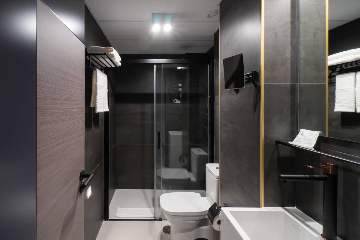 shower, rainfall showerhead, hair dryer, towels