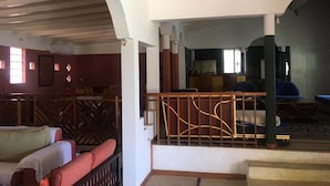 A spacious living area with a staircase, a balcony with a railing, and a seating area with sofas. - House (Saly)