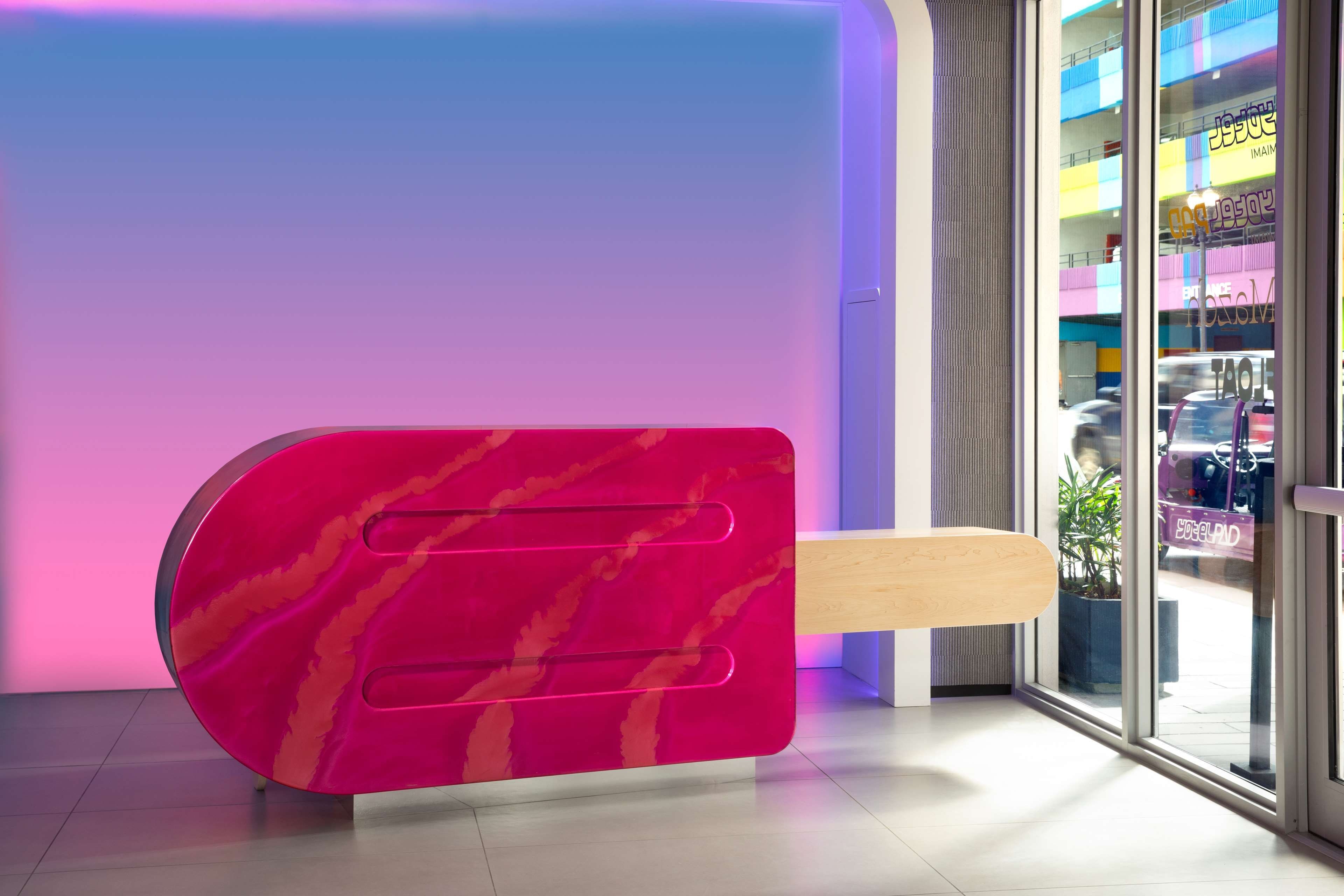 A modern reception desk with a unique ice cream-themed design.