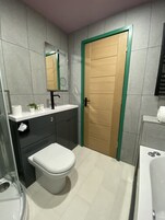 Deluxe Apartment | Bathroom | Designer toiletries, hair dryer, bathrobes, towels