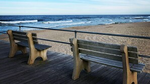 A wooden pier with benches overlooking a beach and ocean. - Studio w/ Kitchenette 2 Blocks to Beach & Main Ave | Near Asbury Boardwalk (Ocean Grove)