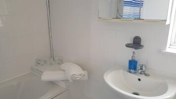 Combined shower/tub, hair dryer, towels, toilet paper