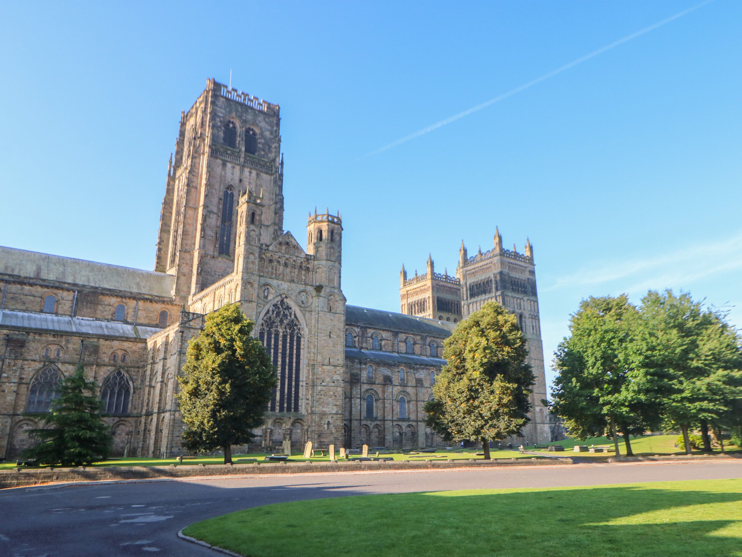 A large historic building with a prominent tower and arched windows.