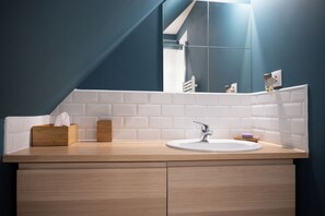 A bathroom with a white sink, wooden cabinets, and a mirror. - Villa with magnificent unoverlooked sea view - 150m2 (Veulettes-sur-Mer)
