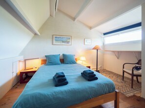 A bedroom with a bed, two pillows, a lamp, a chair, and a window. - Villa with magnificent unoverlooked sea view - 150m2 (Veulettes-sur-Mer)
