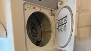 A front-loading washer and dryer unit with a control panel, installed in a corner of a room. - Casita del Wow Private Studio Brickel Miami walk to restaurants 5 Min Mia Beach! (Miami)