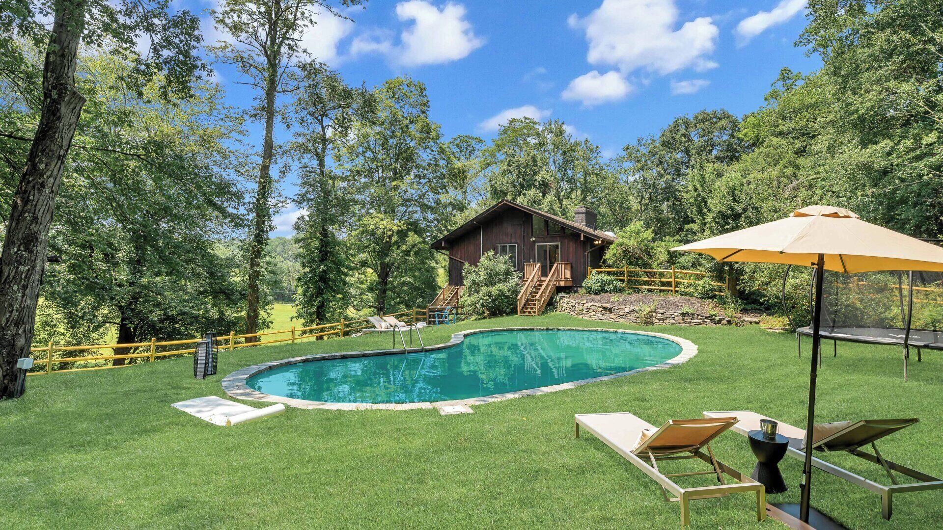 Mid-century home on seven serene acres of rolling meadows with private pool...