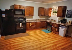 Kitchen features an oven, sink, and refrigerator.