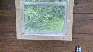 A window with a view of a dense forest. - Hollering Pines Retreat-Great for Military, Fugitive Beach, in Mark Twain Forest (Newburg)