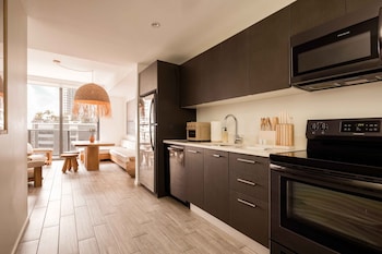 3 Bedroom Suite with River View | Private kitchen | Full-size fridge, microwave, oven, stovetop at Flow Fort Lauderdale Hotel