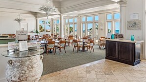 A spacious dining area with high ceilings and large windows, featuring a central island with a rustic pot and a sign reading "Chef Showdown". - Beach Club A1406: K/Q,TT,sofa sleeper Direct Gulf View-Pack n Play - Pools/Beach (Gulf Shores)