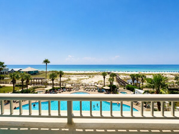 A resort with a pool, beach, and ocean view.
