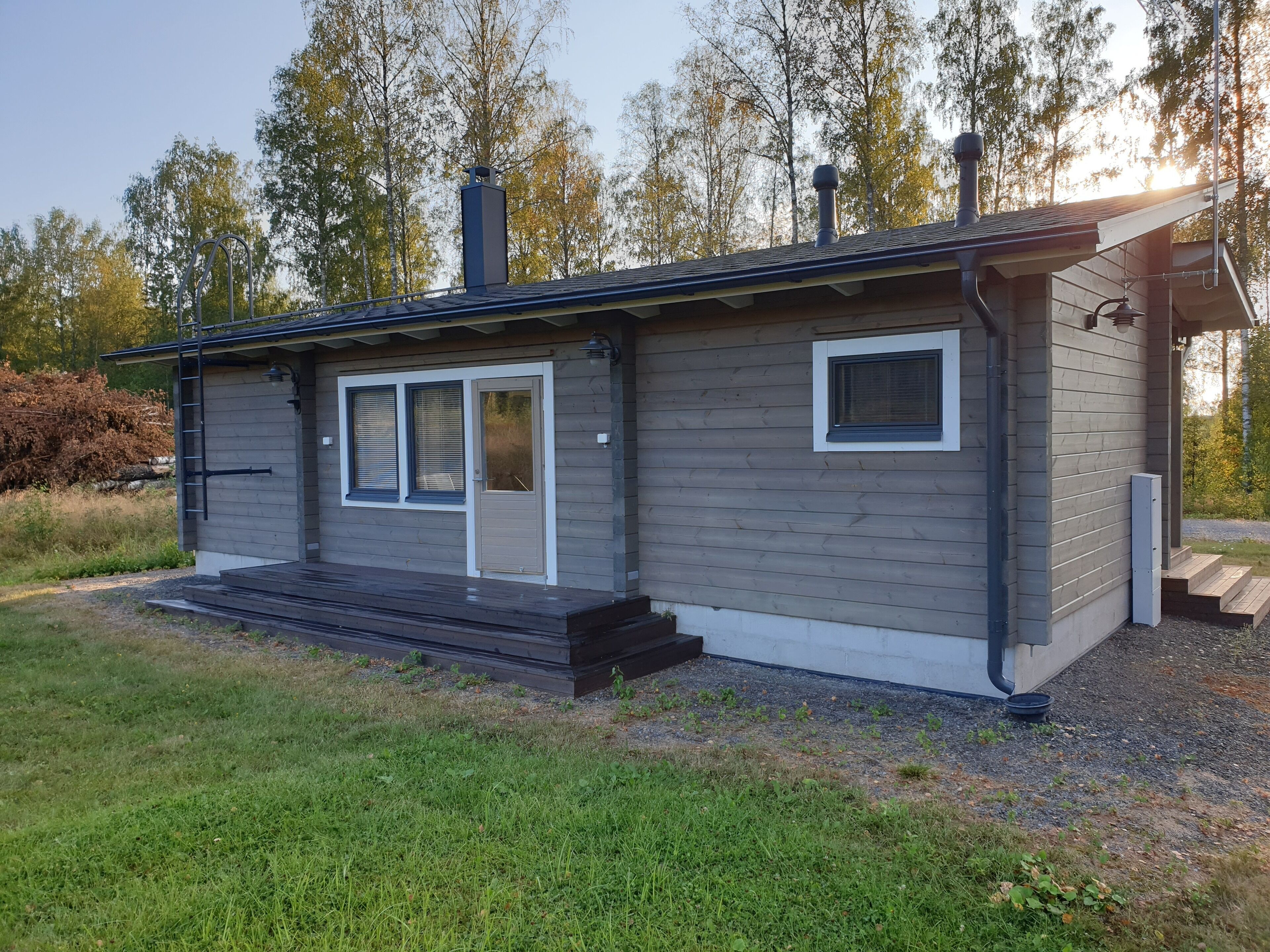 A single-story house with a front porch, a garage, and a small attached shed.
