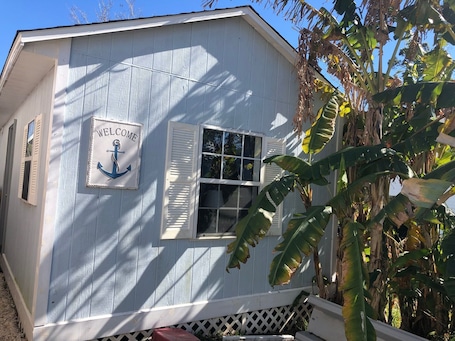 Exterior detail. Waterfront Cozy Cottage, Walk to restaurants, yet private waterfront retreat.