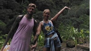 Two people standing in a natural setting with a mountainous background. - Hawaiian Princess Paradise (Honolulu)