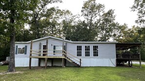 A single-story house with a front porch and a small deck. - Lake Home  (Pontiac)