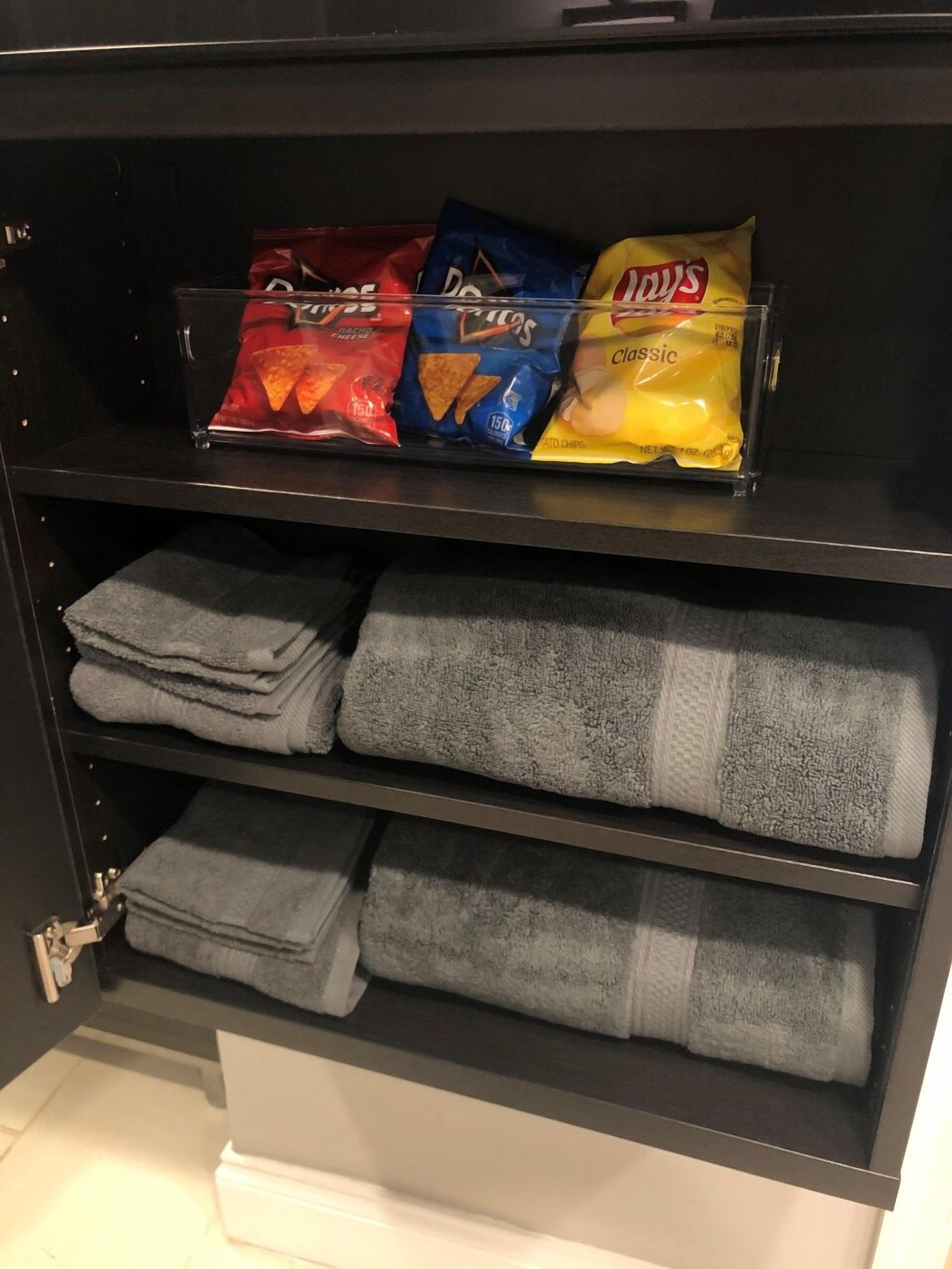 A shelf with snacks and towels.