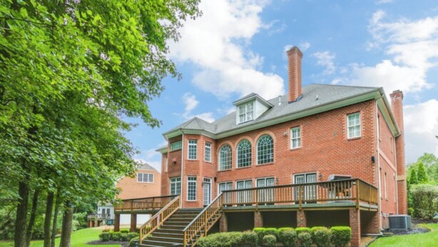 A large brick building with a central staircase, multiple windows, and a well-maintained lawn. - Great Get Away Home  (Henrico)