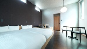 A modern hotel room with a large bed, a desk, and a chair. - Rakuten STAY Hakata Gion (Fukuoka)