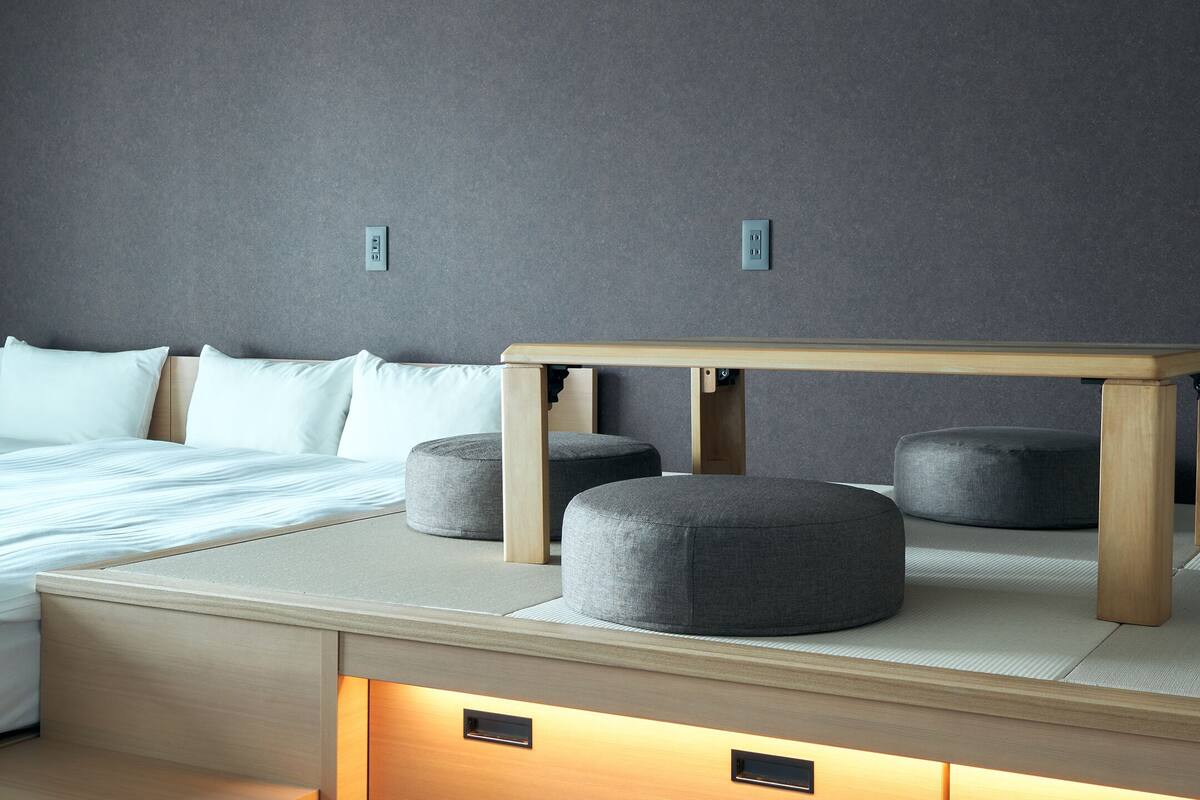 A modern bedroom with a bed, bedside tables, and a nightstand.