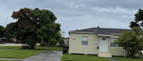 A single-story house with a front yard, a mailbox, and a number '211' on the door.