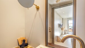 A bathroom with a sink, mirror, and shower. - Avgoustos Suites - Adults only (Naxos)