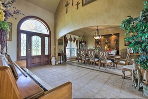 Enjoy a spacious room with a grand piano, dining area, and elegant staircase.