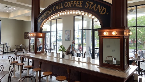 A coffee stand with a sign reading "Morning Call Coffee Stand" in a cafe with bar stools and tables. - Canal DOWN |Streetcar Line MidCity| Add More Space (New Orleans)