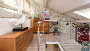 A modern interior with a wooden bench, a globe, and a framed picture on the wall. - Superb loft apartment in the heart of old Antibes 3mns from the beach (Antibes)