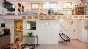 A compact, modern apartment with a loft bedroom, a dining area, and a kitchenette. - Superb loft apartment in the heart of old Antibes 3mns from the beach (Antibes)
