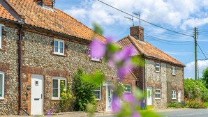A stone building with a tiled roof, a white door, and windows. - Willow Cottage (SC), South Creake, Norfolk (South Creake)