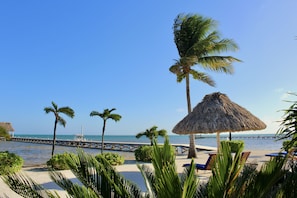 On the beach, white sand, sun-loungers, beach towels
