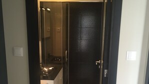 A modern bathroom with a glass shower enclosure, a sink, and a toilet.