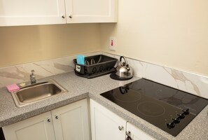 Fridge, microwave, stovetop, coffee/tea maker