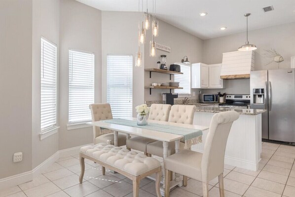 Enjoy cooking and dining in this well-equipped kitchen with stainless steel appliances and a spacious dining area.