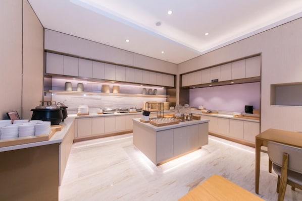 A modern kitchen with a central island, built-in appliances, and a minimalist design.