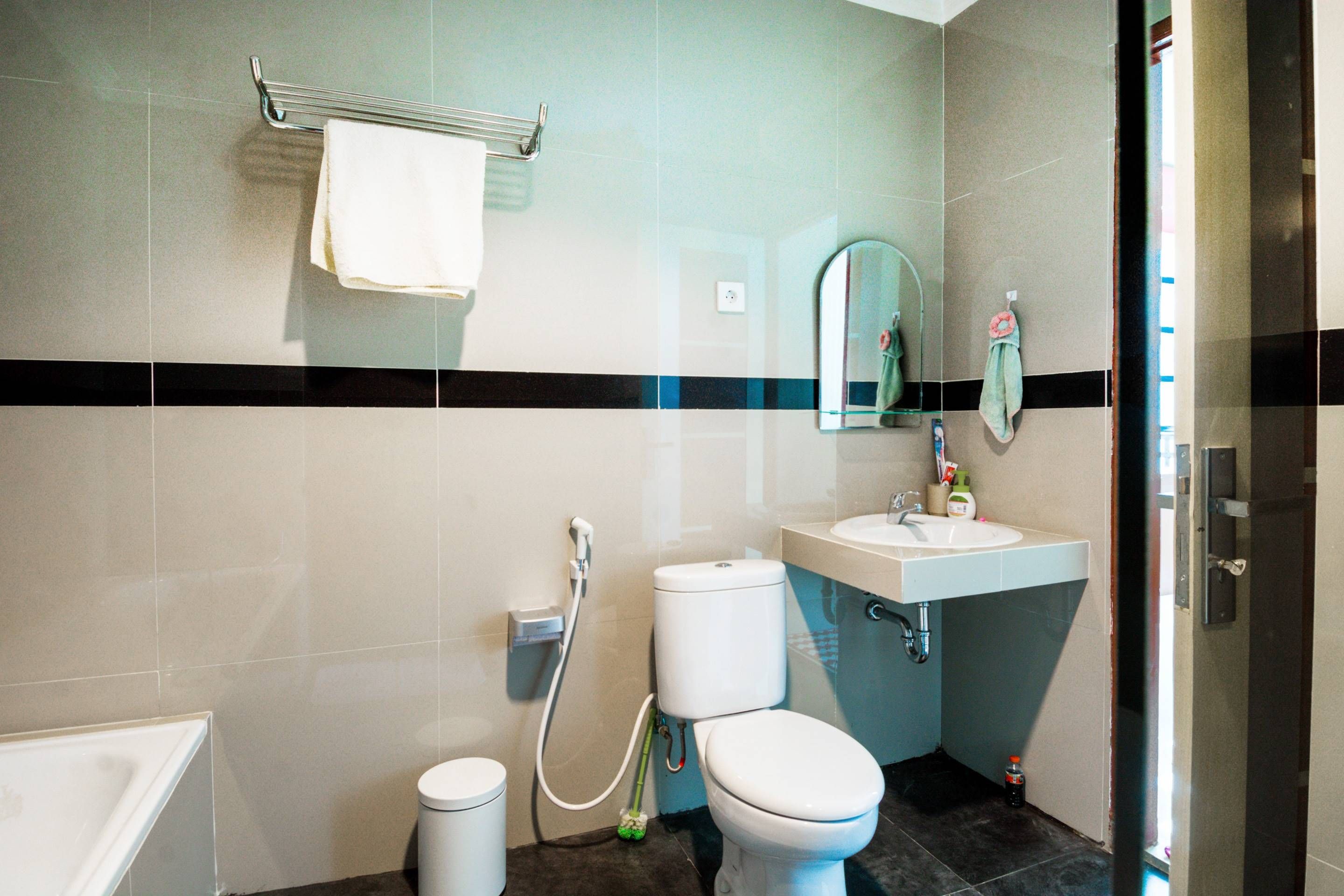 A bathroom with a toilet, sink, and shower.