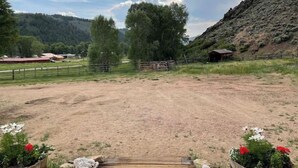 A rural landscape with a dirt path leading to a wooden gate, surrounded by fences and greenery. - Ursa Miner - quiet, dark sky, 6 miles from Pitkin! (Parlin)