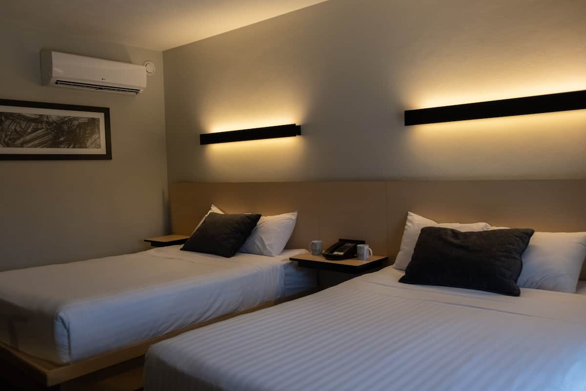 Standard Quadruple Room | In-room safe, desk, laptop workspace, iron/ironing board