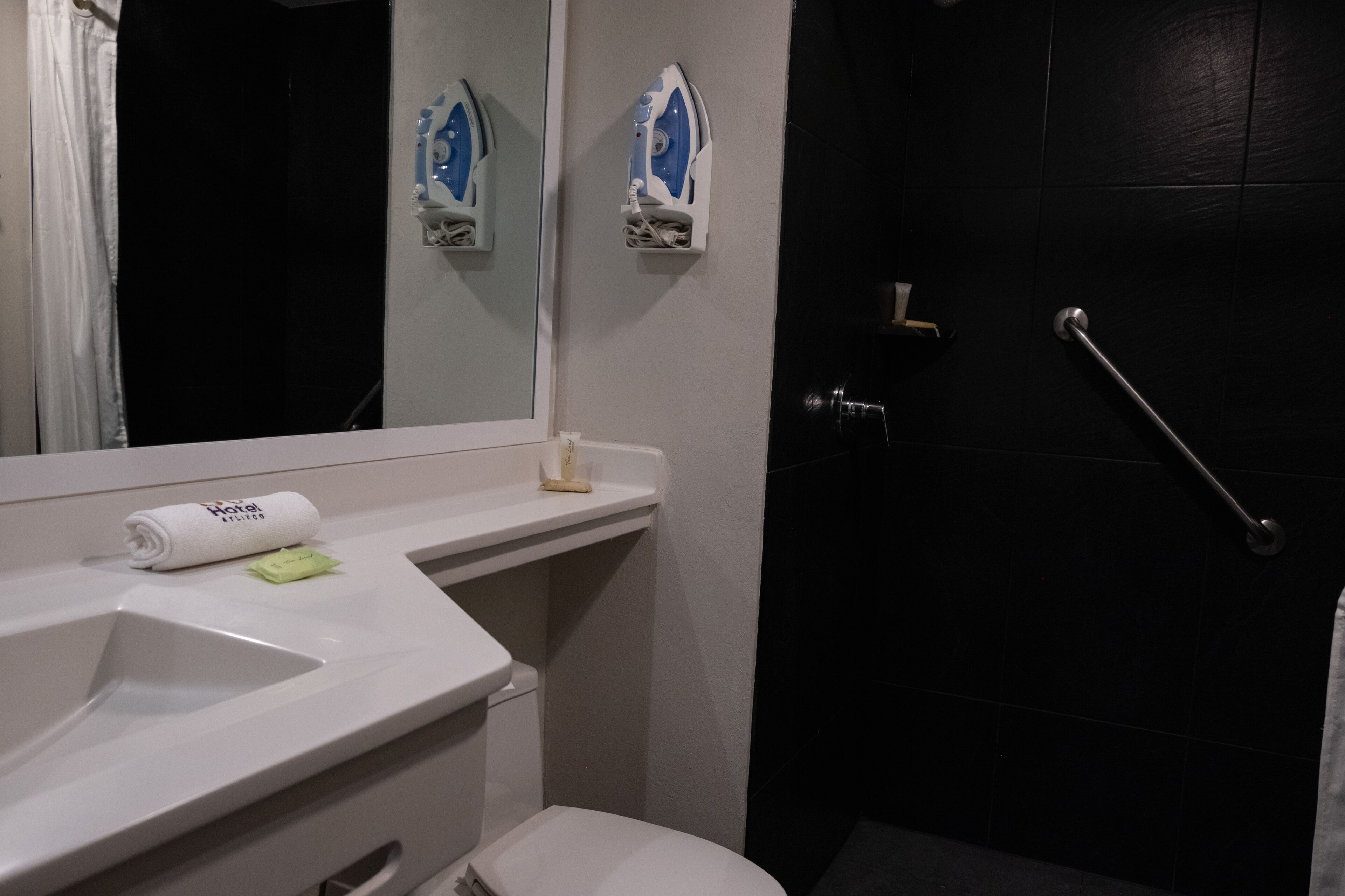 deluxe studio suite | bathroom | shower, hair dryer, towels
