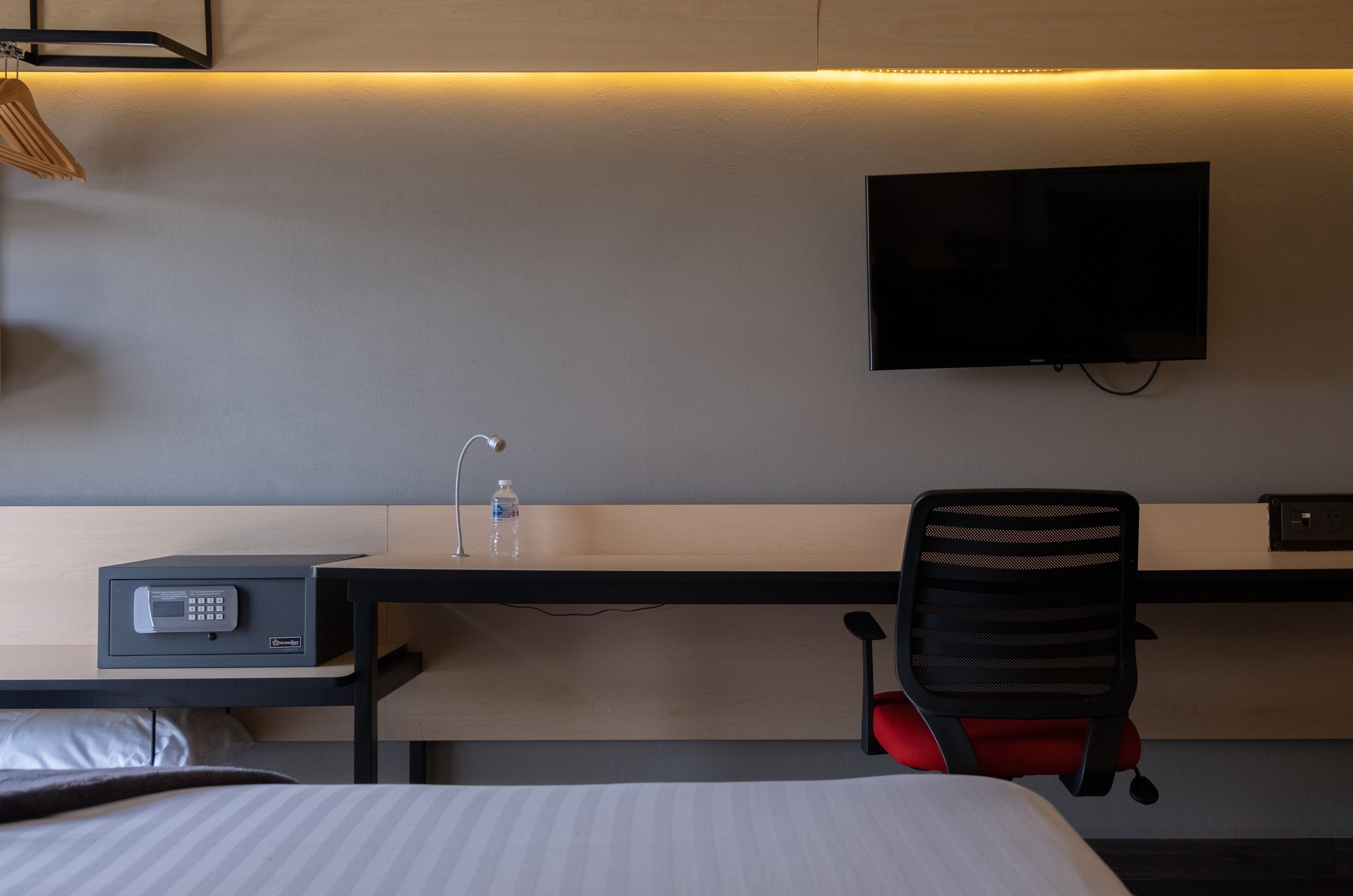 deluxe studio suite | in-room safe, desk, laptop workspace, iron/ironing board