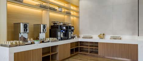 A modern kitchen with built-in appliances, wooden cabinets, and a marble countertop.