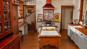 A kitchen with wooden cabinets, a central island, and a stove. - Orchard & Mountain Views, 5Mi Wintergreen, Gourmet Kitchen (Massies Mill)